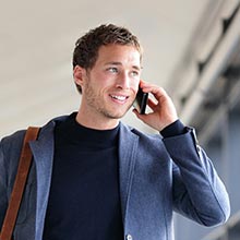 business man talking on mobile phone in airport mobile